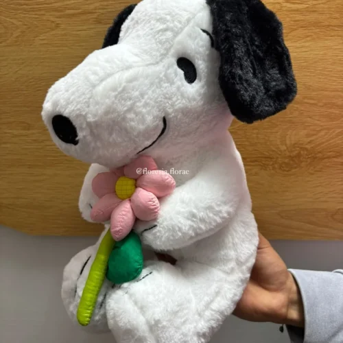 Peluche de Snoopy sosteniendo una flor rosa para regalo tierno.